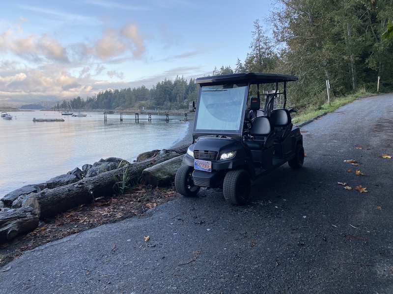 Low Speed Vehicle rented from Bowen eBikes is parked at Tunstall Beach on Bowen Island.